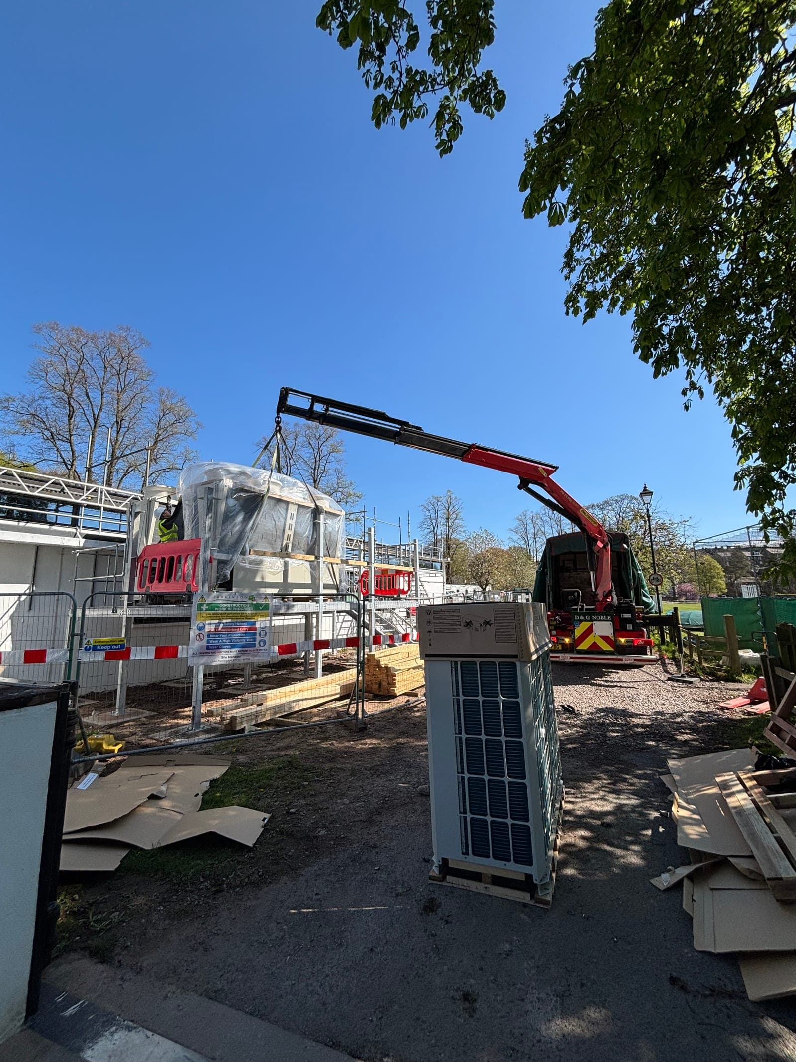 Crane lifting the air handling unit into position