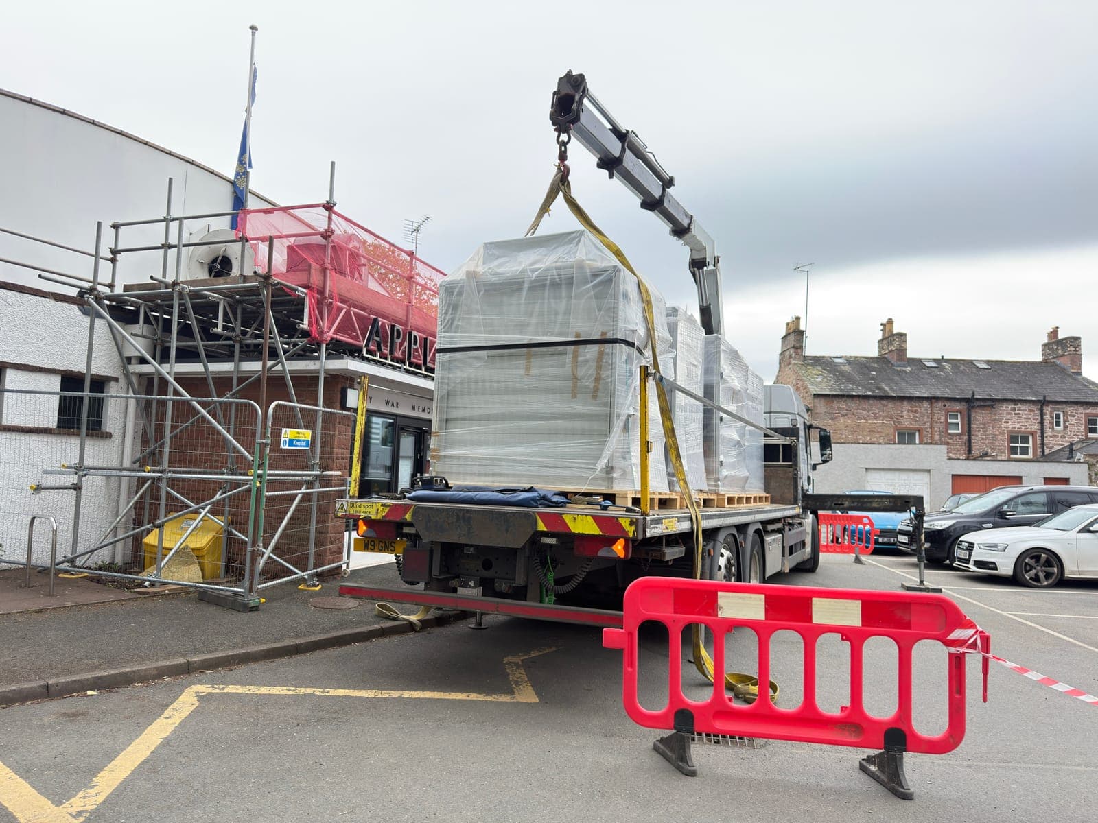 Crane lift over the scaffolded roof