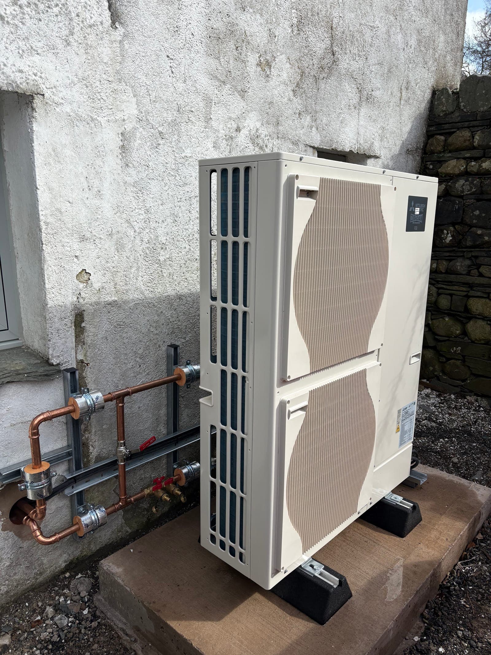 Air source heat pump installed outside the house